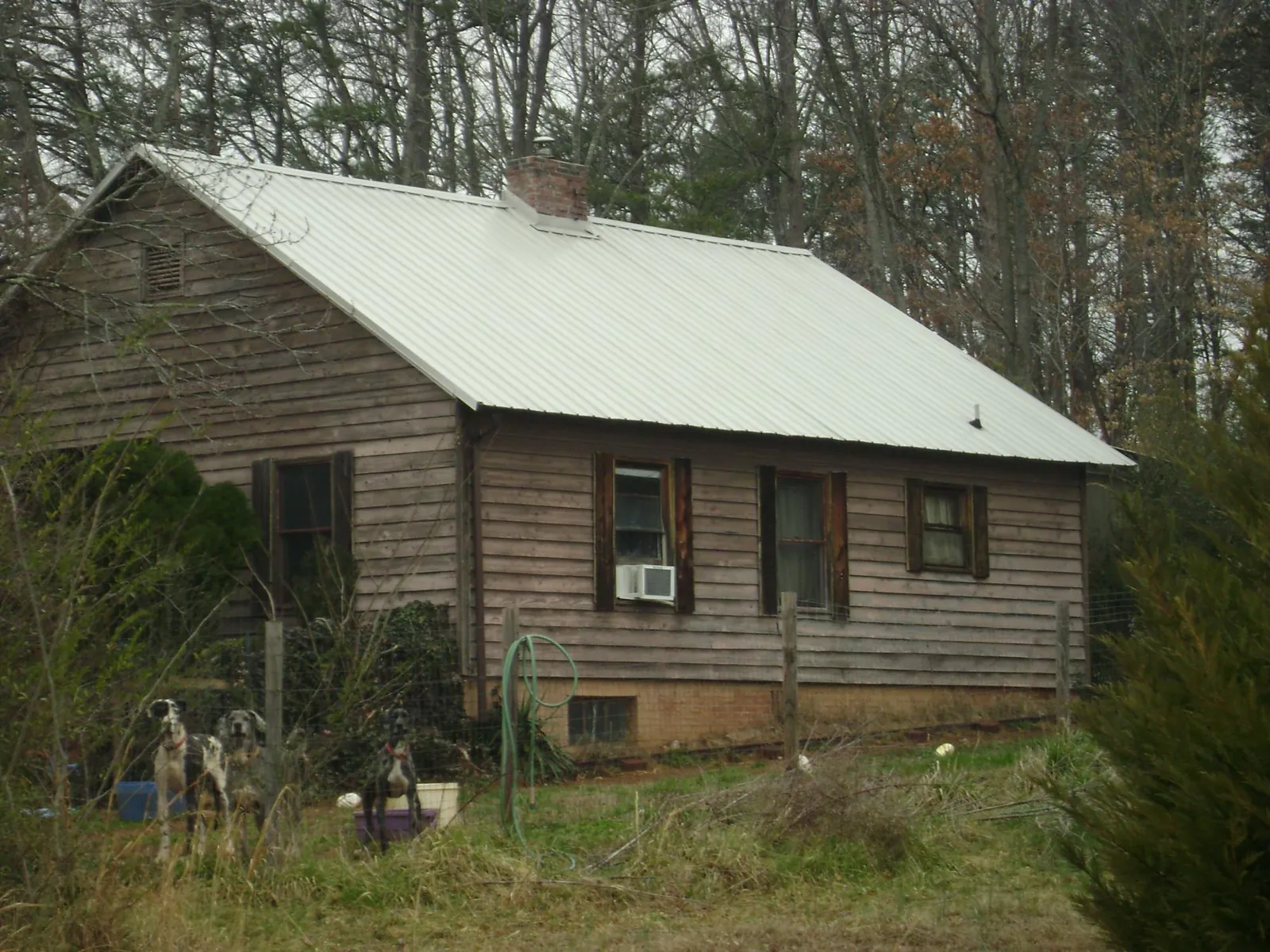 White metal roof on an old wood sided farmhouse, from a Metal Roof Installation job in North Arlington